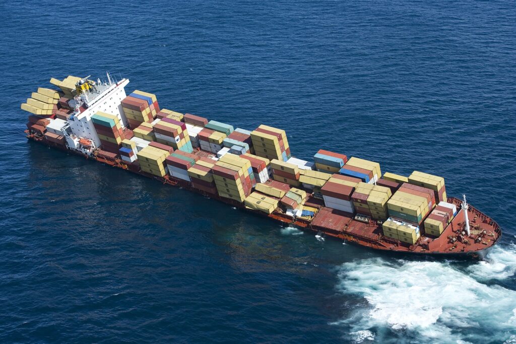 Photo of the grounded ship Rena on the reef, courtesy of New Zealand Defence Force via Flikr CC by 2.0
