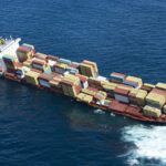 Photo of the grounded ship Rena on the reef, courtesy of New Zealand Defence Force via Flikr CC by 2.0