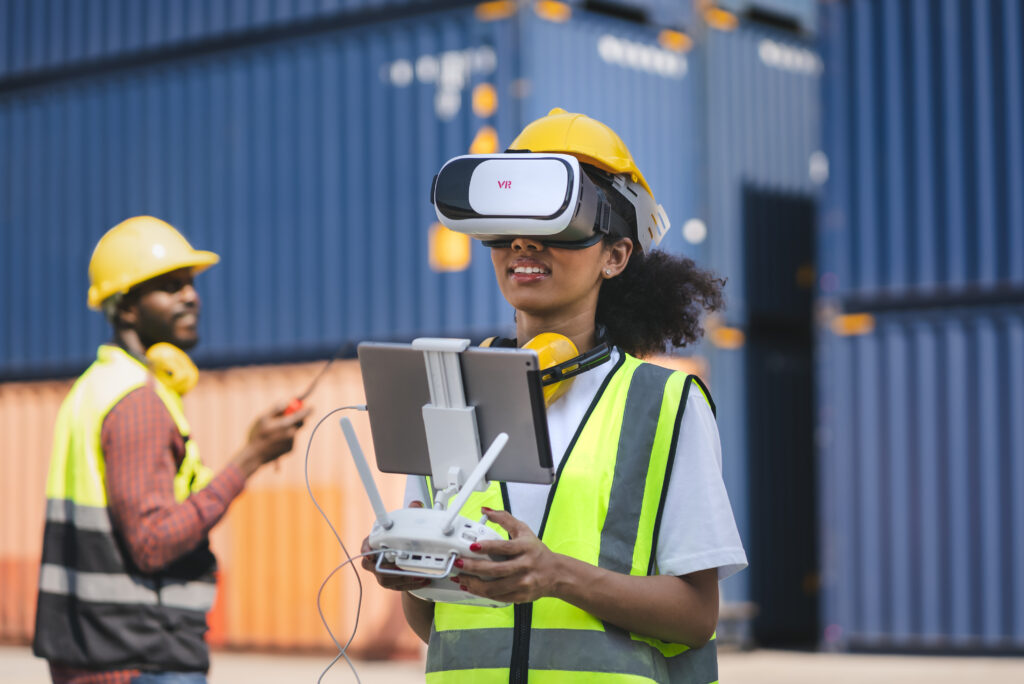 Engineer uses VR headset to remote control drone with blue containers background
