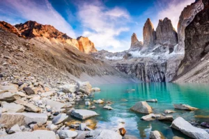 Photo of mountains, rocks, and water in Torres del Paine, Chile.
