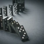 Photo of row of dominos starting to fall
