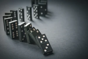 Photo of row of dominos starting to fall