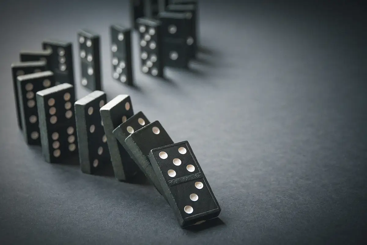Photo of row of dominos starting to fall