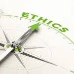 Photo of a compass pointing to the word "Ethics"