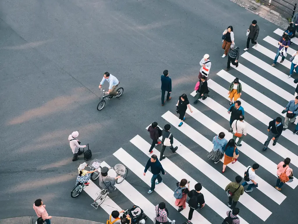 Aerial photo of people crossing a busy urban crosswalk