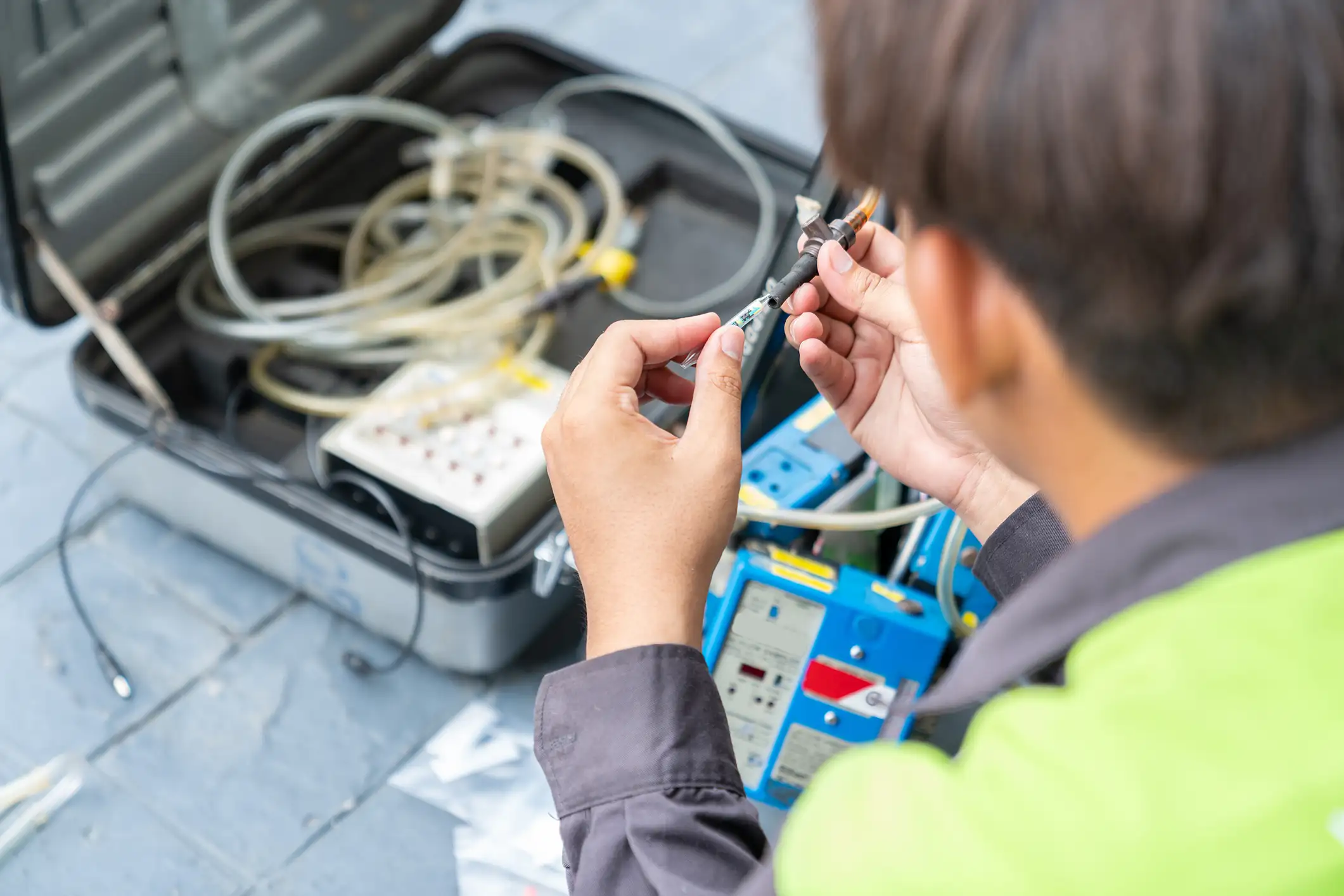 Photo of technician ware sampling tube air quality in reel of machine pump