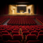 Empty red chairs in a large auditorium