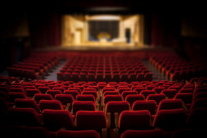 Empty red chairs in a large auditorium
