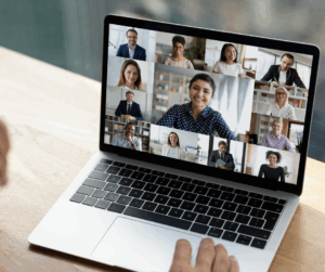 Closeup photo of laptop screen showing colleagues on a Zoom meeting.