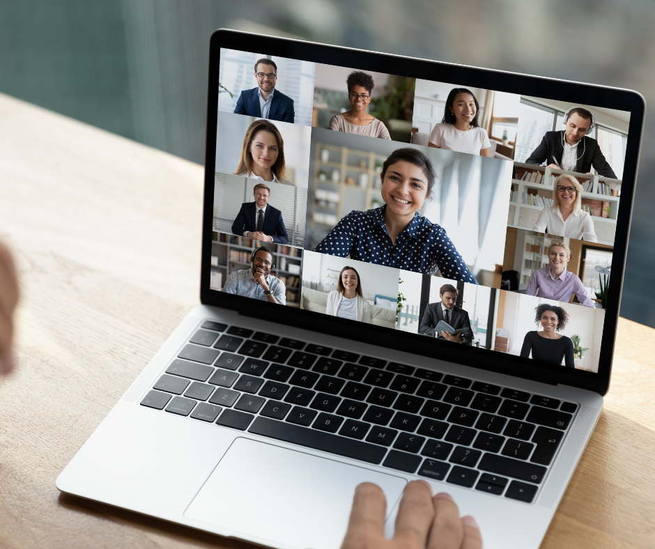 Closeup photo of laptop screen showing colleagues on a Zoom meeting.