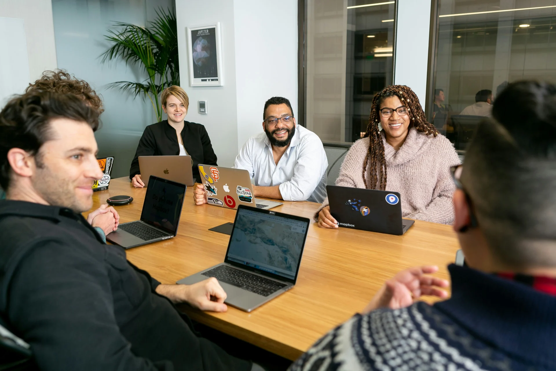 Group of people with laptops seated at conference table - conflict management insights